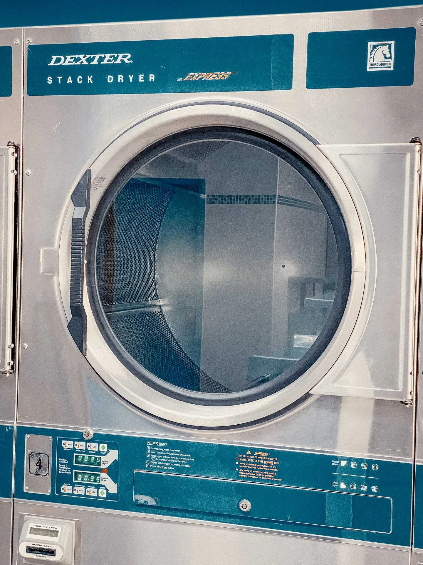 Commercial Dexter Express stack dryer with digital controls and drum visible from front.